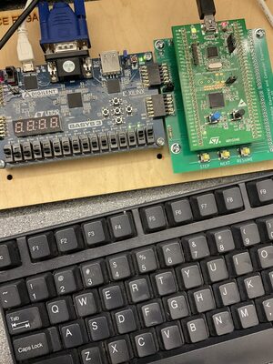 Basys 3 running the CPU, with the bootloader host board.